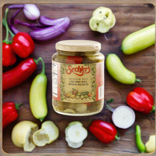 Jar of Hot Chunky Dill Mixed Pickles on wooden cutting board surrounded by various kinds of peppers and onions. 