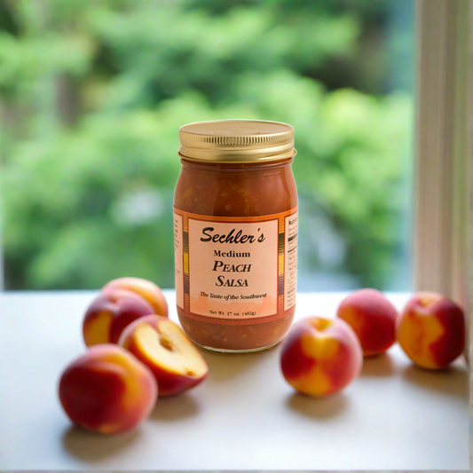 Medium Peach Salsa on kitchen countertop with fresh peaches