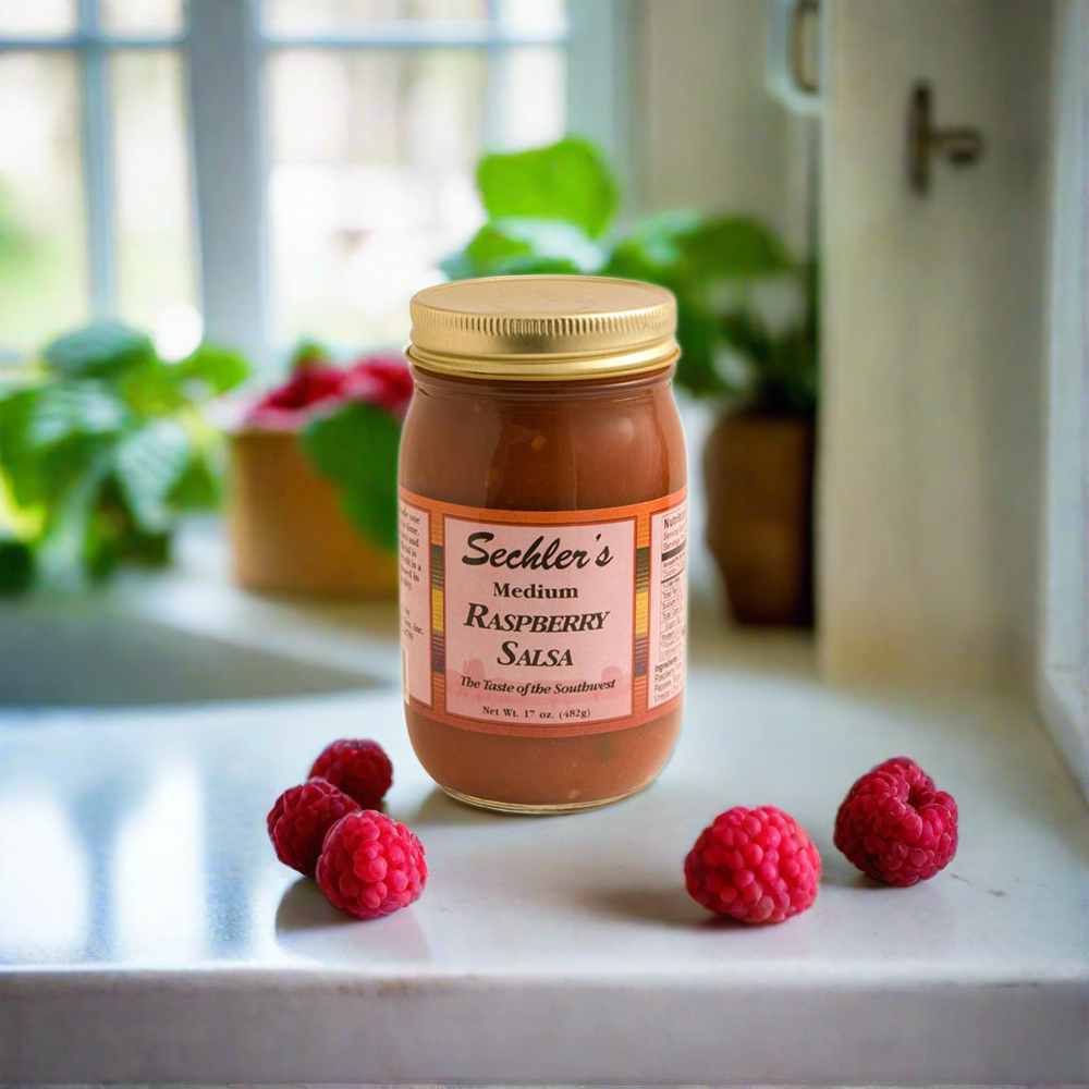 Medium Raspberry Salsa on kitchen countertop with fresh red raspberries