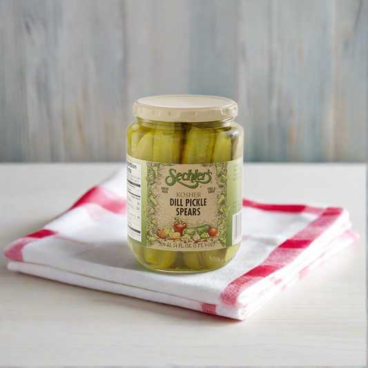 Jar of Kosher Dill Pickle Spears on kitchen countertop with red and white napkin. 